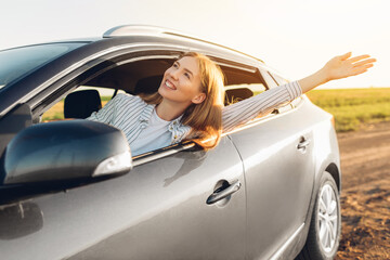 Wall Mural - Close up portrait of young woman, content with travel by car, sitting on driver's seat