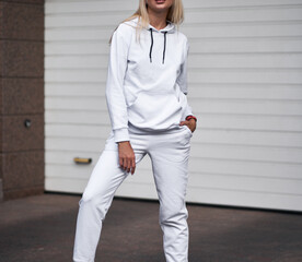 Poster - for Girl wears white hoodie and pants. Blonde woman in loose tracksuit with no logo