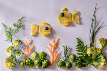 sea world, creative meal, image from fruit and vegetables in yellow and green colors, isolated