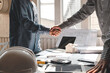 © amnaj - Architect man shaking hands with Customer to build home success at the office.