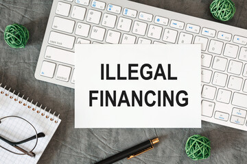 Illegal financing is written in a document on the office desk