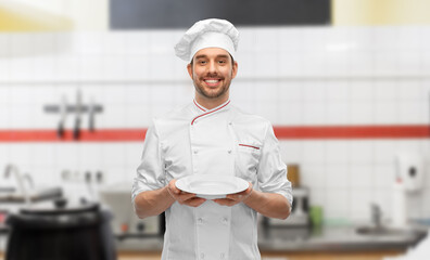 Wall Mural - happy smiling male chef holding empty plate