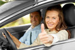 car driving instructor and woman showing thumbs up
