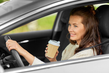 Wall Mural - woman or female driver with coffee driving car