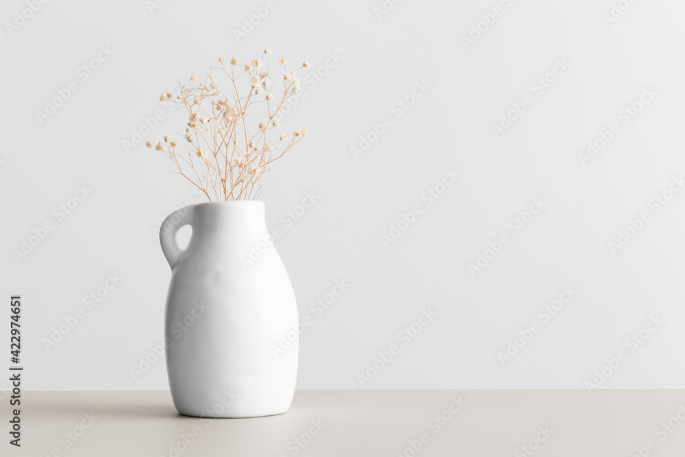 Dried gypsophila in a vase on a beige table. Flat lay with blank copy space. - obrazy, fototapety, plakaty 