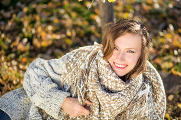 Beautiful woman wearing knitted sweater in autumn scenery	