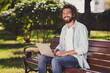 © deagreez - Photo of cheerful attractive afro american man sit bench good mood wear glasses in park outside outdoors