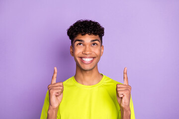 Sticker - Photo of young african guy happy smile look indicate fingers empty space ad promo select suggest isolated over violet color background