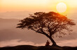 © ittipol - Buddhist monk in meditation under the tree at beautiful sunset or sunrise background