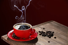Cup Of Hot Coffee And Steam In Shape Of Human Body On Dark Color Background