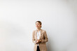 © BGStock72 - Young woman standing by the white wall in modern office