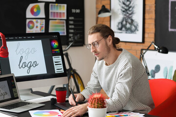 Young male designer working in office