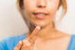 © Ioritz Lopez/ADDICTIVE STOCK - Crop blurred smiling female preparing to put in contact lens on fingertip in light room