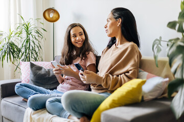 Wall Mural - Single parenthood. Mother and daughter spending time together at home.