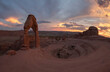 © PACO FARERO/ADDICTIVE STOCK - Amazing landscape with arched formation in red rock near rare vegetation located in national park against cloudy sky in USA