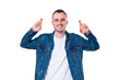 © Vulp - Photo of young cheerful man in blue jeans crossing fingers and wishing