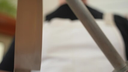 Chef Sharpening Knife Holding in Hand, Isolated Action with Copy Space
