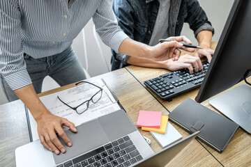 Wall Mural - two professional programmer cooperating and working on web site project in a software developing on 
