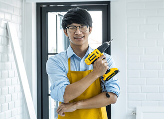 Portrait of Craftsman doing renovation work at home improvement with holding drill and interior design concept