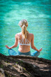blonde woman doing yoga at the green lake in Styria, Austria