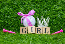 Golf Ball With Pink Ribbon For Baby Girl On Green Grass