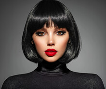 Beautiful Brunette Girl With Red Lips And Black Bob Hairstyle. Pretty Young Woman With Black Hair. Closeup Portrait Of A Model With Bright Makeup On A Face. Fashion Portrait Of A Pretty Lady.