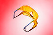 © fStop - Yellow safety goggles on red background