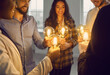 © Studio Romantic - Multiethnic business team standing in circle holding glowing lit retro light bulbs. Group of happy multiracial people join shining vintage Edison lightbulbs. Teamwork, sharing creative ideas concept