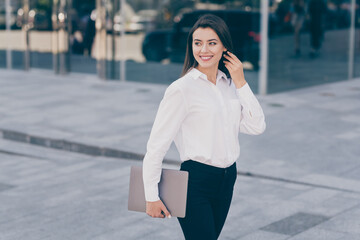 Sticker - Photo of young beautiful gorgeous charming businesswoman hold laptop look copyspace go walk outside outdoors