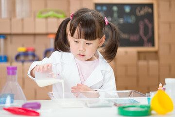 young girl plays science experiment for home schooling