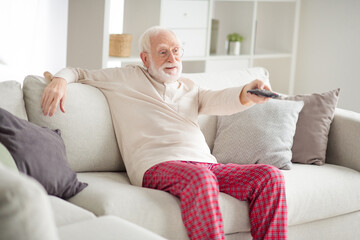 Sticker - Photo of aged man pensioner sit couch home rest relax look watch tv cinema switch channel remote controller