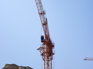 The tower crane on the construction site is busy working