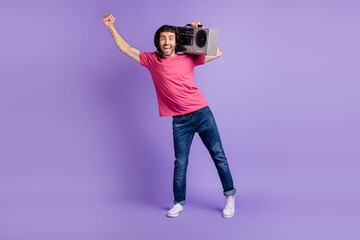 Wall Mural - Full size photo of optimistic nice brunet guy listen boom box wear pink t-shirt isolated on violet background