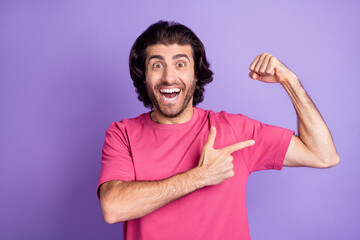 Wall Mural - Photo of impressed nice brunet guy point arm wear pink t-shirt isolated on pastel violet color background