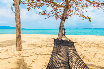 Wall Mural - Empty hammock swing around beach sea ocean with white cloud blue sky