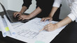 © Puwasit Inyavileart - Meeting of engineers and architects in building planning, Consulting and brainstorming experts in architectural planning using blueprints, tape measure, rulers, laptop in designing buildings.