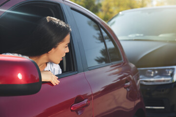 Wall Mural - Young woman getting in car accident outdoors