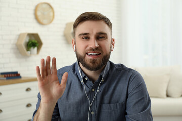 Sticker - Young man with earphones holding online webinar indoors, view from webcam