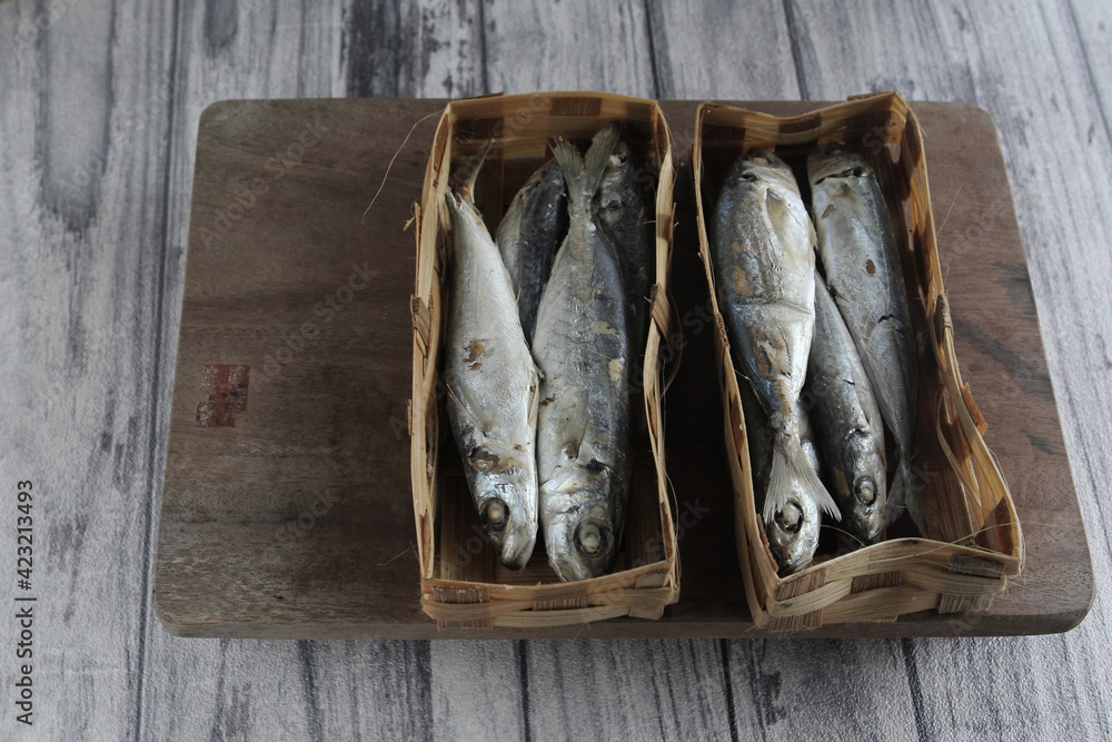pindang fish (salted fish) in a bamboo container, is one of the ...