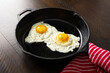 Fried eggs in a cast iron skillet.