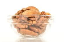 Several Ripe Peeled Pecans In A Glass Dish, Close-up, Isolated On White.