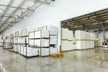 Spacious Light Interior Of A Large Warehouse In A Factory With Special Racks And Shelves And Products Placed On Them.