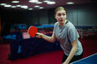 © glebcallfives - Portrait of a young girl table tennis player with racket playing ping pong