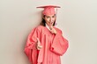 © Krakenimages.com - Young caucasian woman wearing graduation cap and ceremony robe pointing fingers to camera with happy and funny face. good energy and vibes.