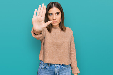 Sticker - Young beautiful woman wearing casual clothes doing stop sing with palm of the hand. warning expression with negative and serious gesture on the face.