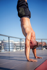 Wall Mural - Sporty man  doing handstand