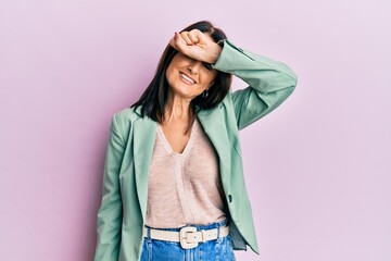 Poster - Middle age brunette woman wearing casual clothes covering eyes with arm smiling cheerful and funny. blind concept.