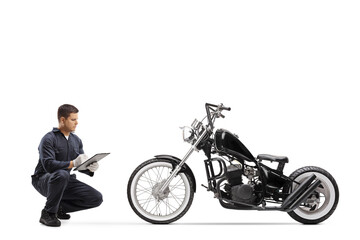 Canvas Print - Bike repairman checking a chopper motorbike