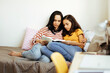 © kleberpicui - Single parenthood. Mother and daughter reading a book together at home.