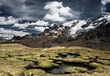 © Tandem Stock - Mountain peaks and what looks like giant moss covered toad stools in a surreal looking landscape located in the Cordillera Huayhuash in the Andes Mountains of Peru.
